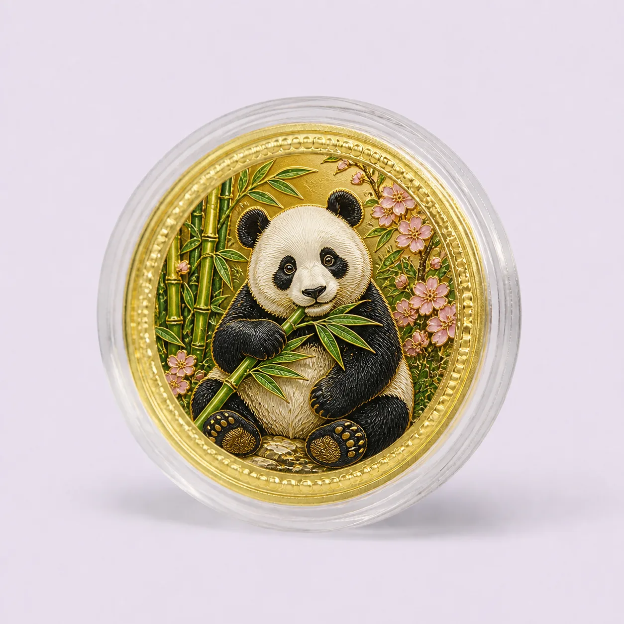 Gold souvenir medallion with raised panda and bamboo artwork in a clear round capsule
